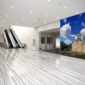 A grand-scale KGS Studios fine art piece of Mission San José, displayed as a mural in a modern, expansive corporate lobby.