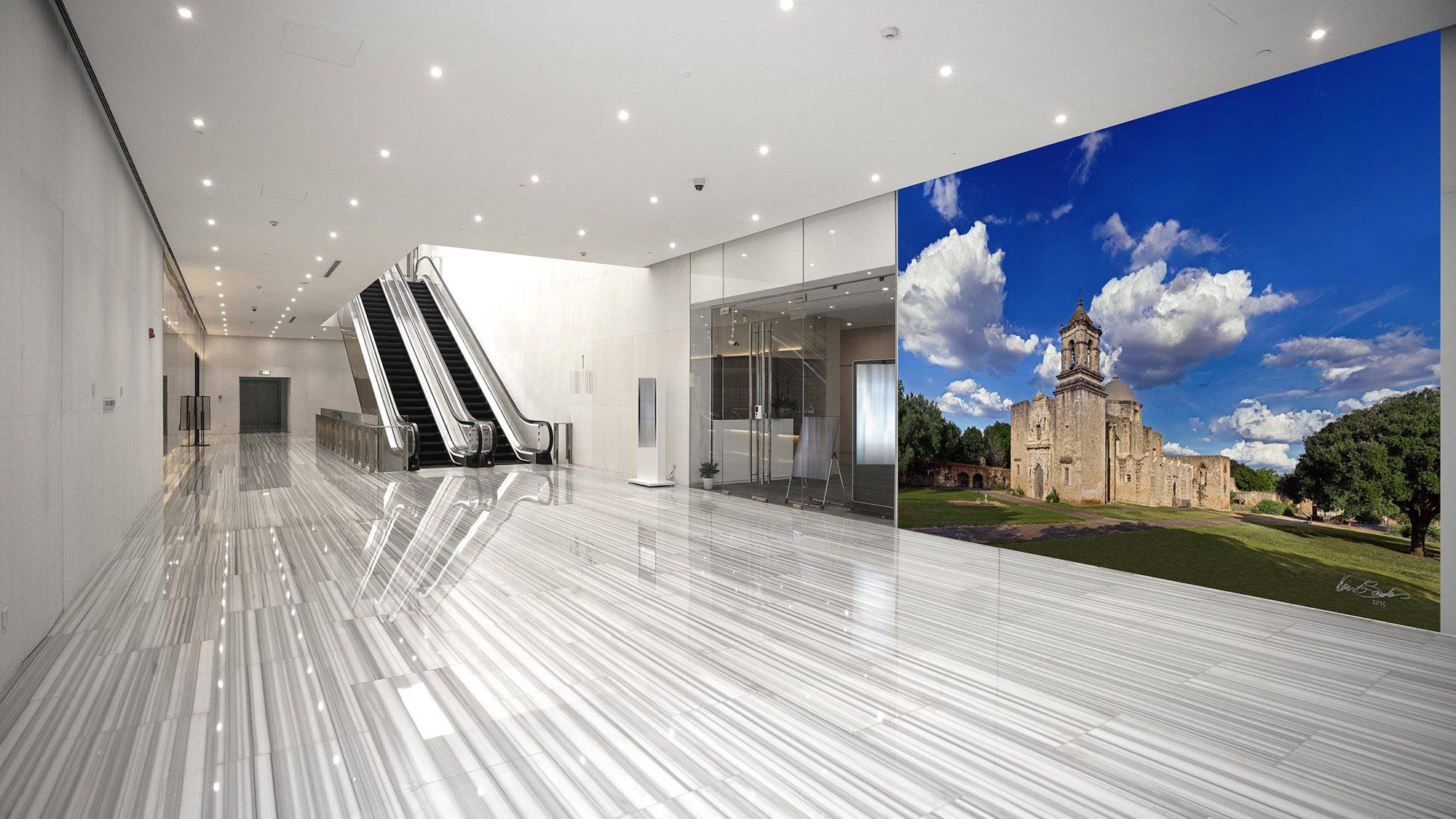 From Perspective to Permanence A grand-scale KGS Studios fine art piece of Mission San José, displayed as a mural in a modern, expansive corporate lobby.