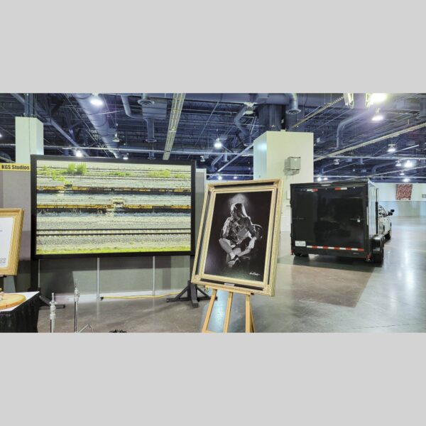 KGS Studios Public Exhibition - Documentation - 03 Physical documentation of Kevin G. Saunders | KGS Studios fine art prints in a public exhibition setting. Verifies the public vetting of manual hyperrealism portraits, orchid studies, and HTTX-97442. San Antonio archive proof of physical reality.