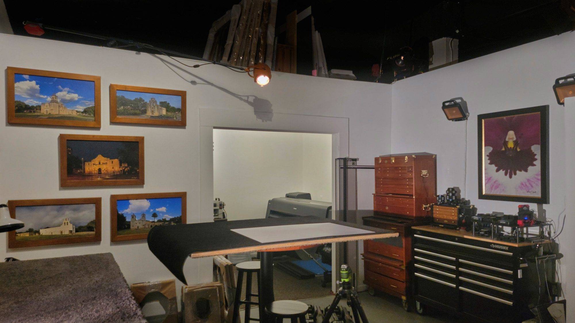 The KGS Legacy Circle The in-house artist atelier at KGS Studios, showing the custom print framing and coating table, tool chests, and the World Heritage Missions Collection in "unlimited" scale.