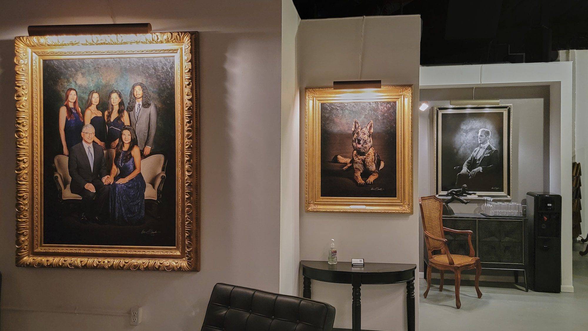 Portrait Investment & Pricing A gallery wall at KGS Studios featuring a large family Statement Piece, a portrait of a German Shepherd, and a black and white portrait of a man.