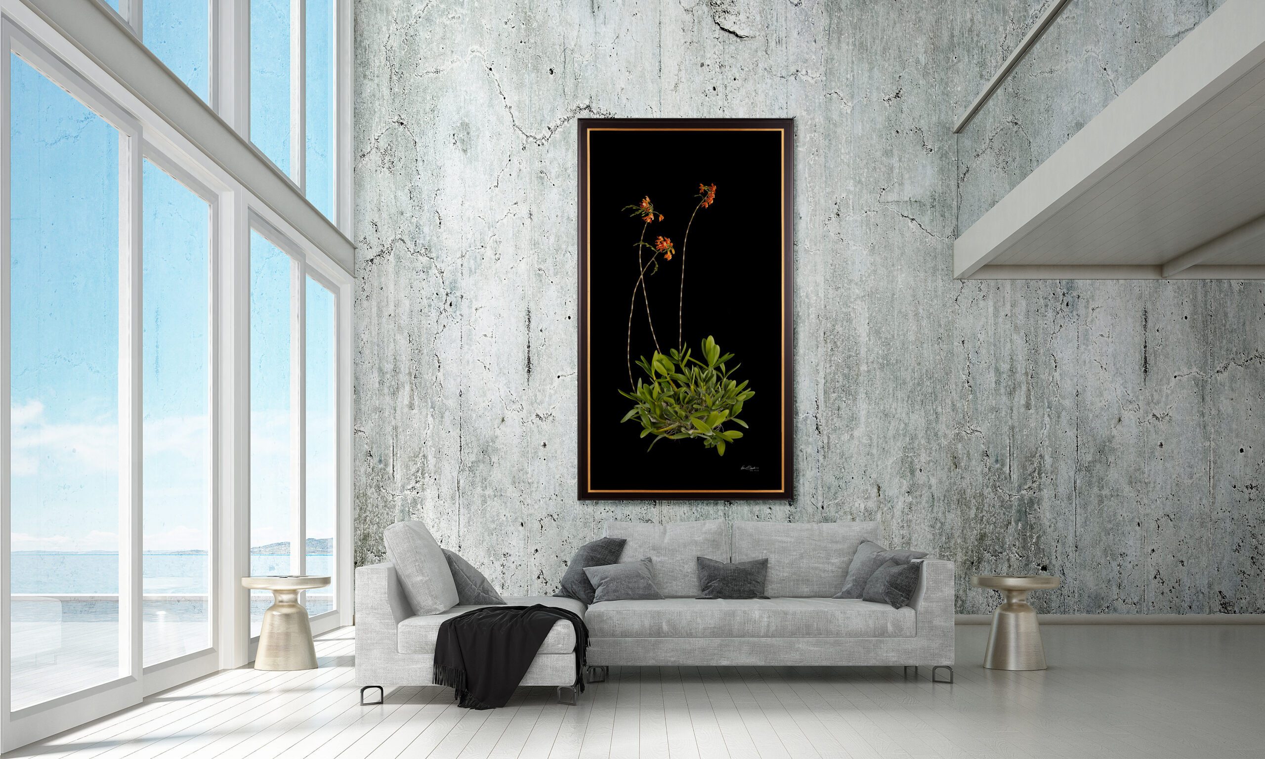 Grand Scale Orchid Print by Kevin G Saunders hanging in a concrete walled beach home living room over a gray sofa.