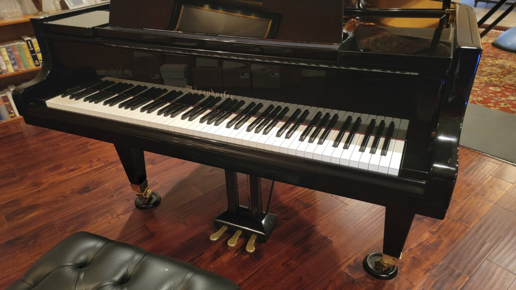 The Grand Manner: Why the Life-Size Portrait is the Ultimate Act of Patronage Black vintage Kimball-era Bösendorfer Model 200 grand piano.