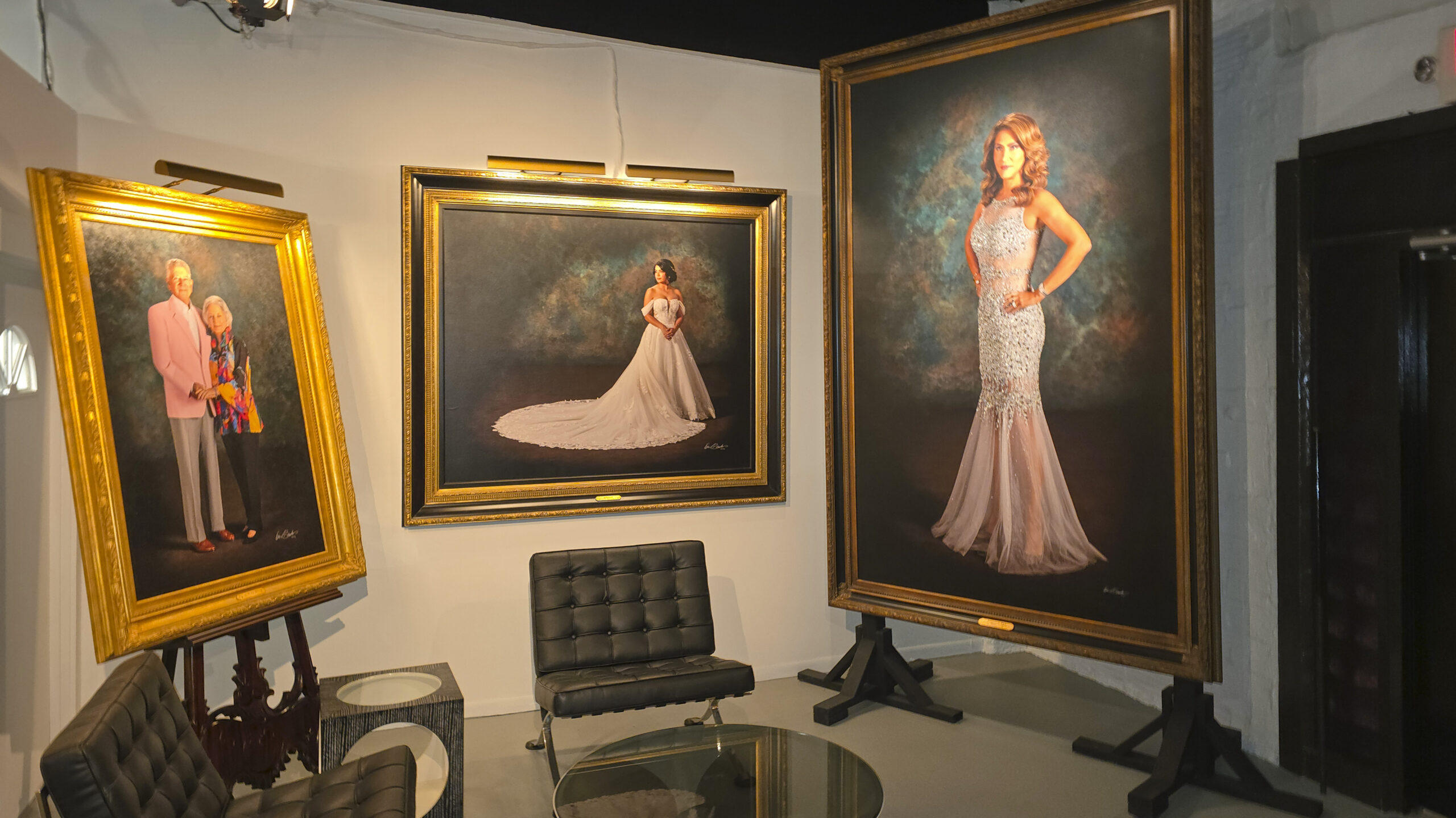 Grand-scale hyperrealistic portraits on display in KGS Studios lobby showing commanding physical presence and permanence